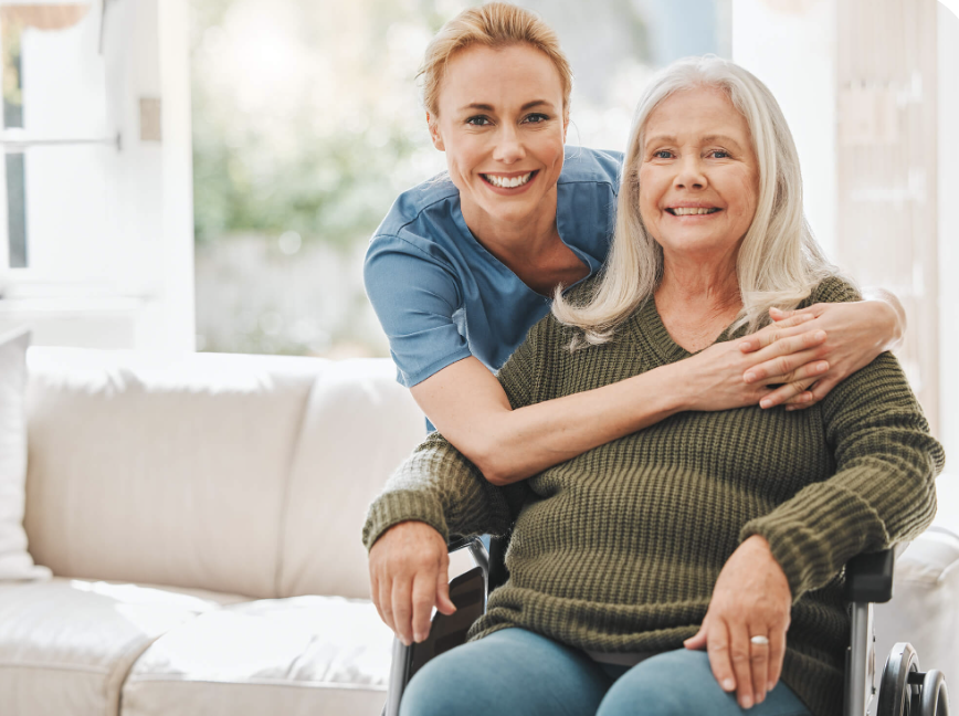 A caregiver and senior client sharing a warm, supportive moment at home